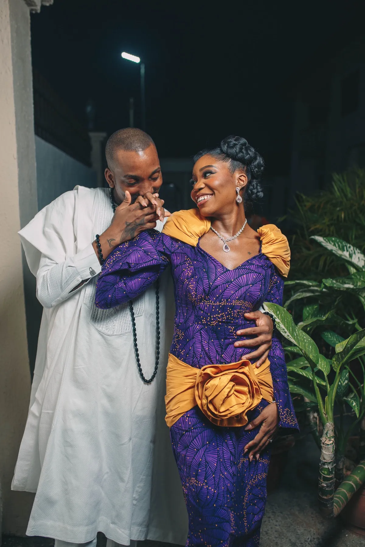 ekanem and adeilé laughing together in white and purple-and-gold attire at the introduction
