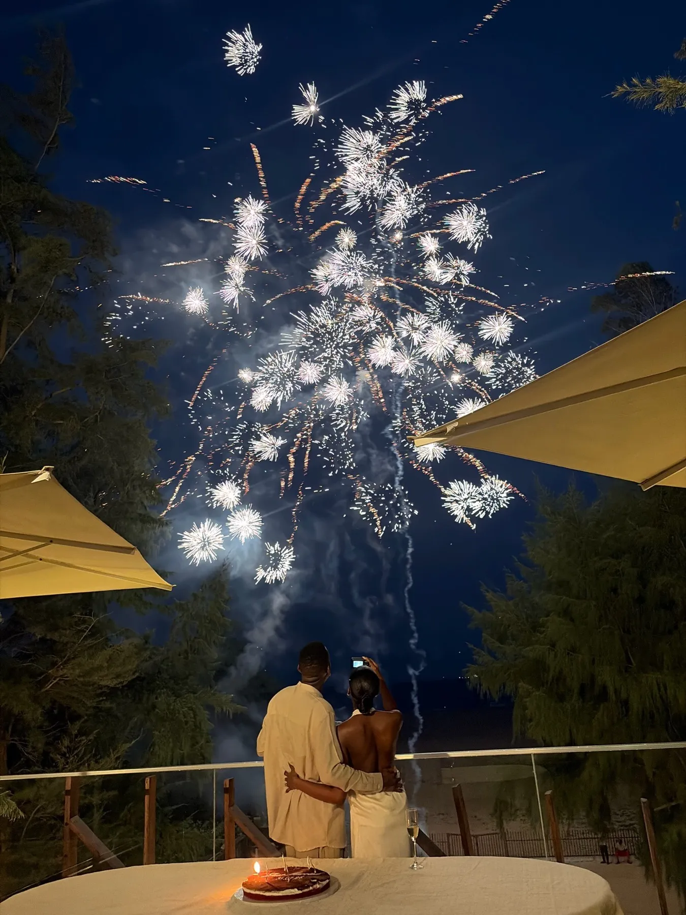 fireworks over the couple on the terrace at night